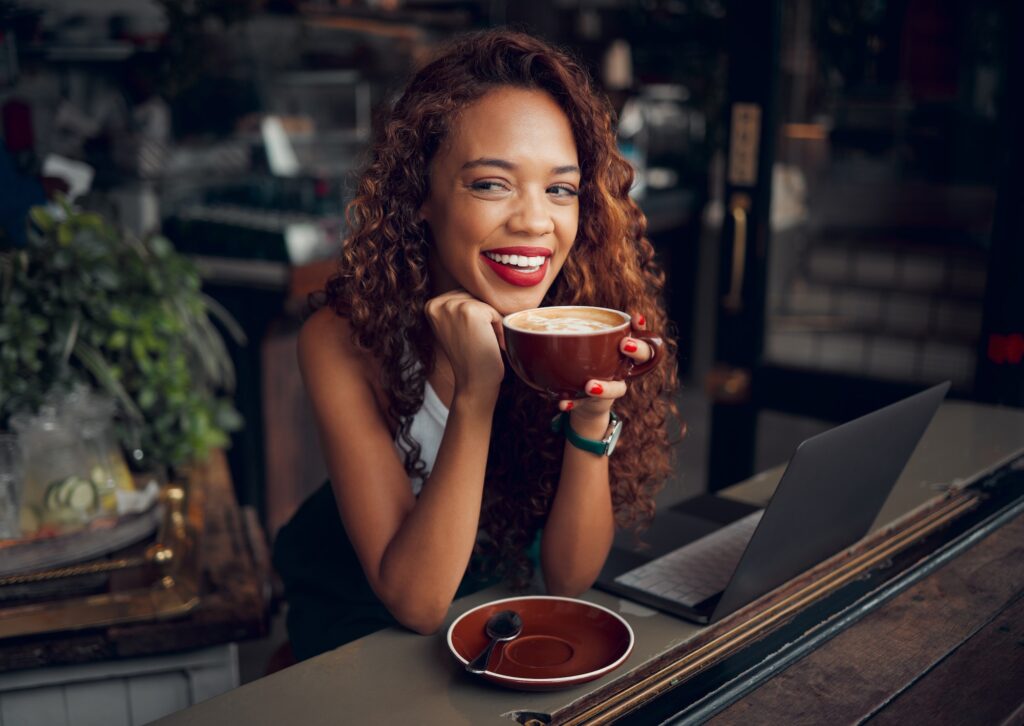 Black woman, coffee at cafe and remote work on laptop for freelance online digital marketing busine